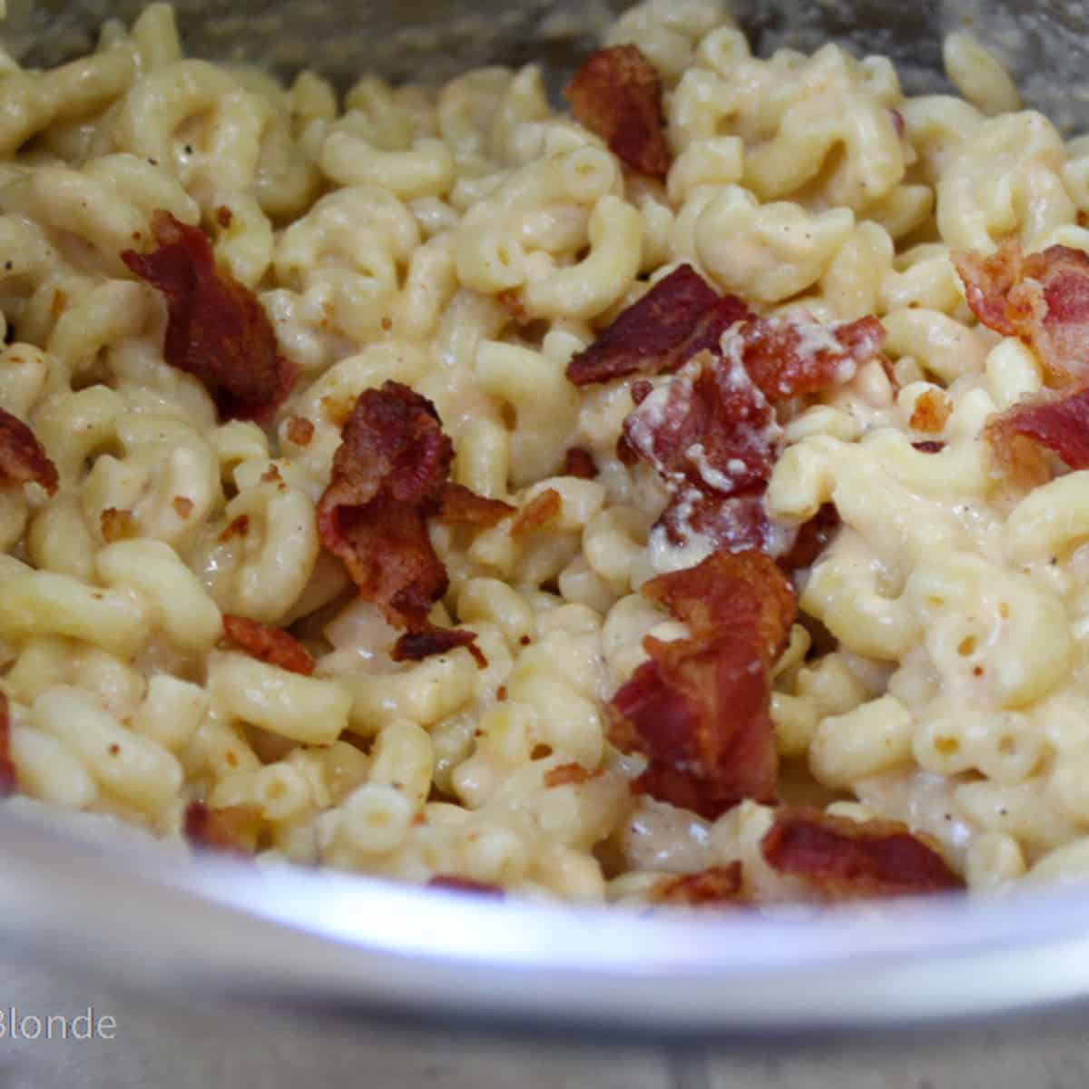 Macaroni and cheese with bacon made in the Instant Pot served up in a white bowl