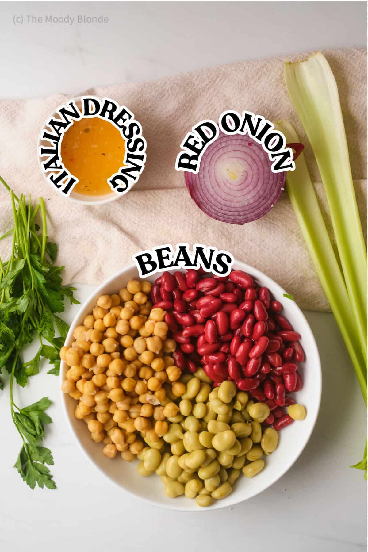 Ingredients for 3 Bean Salad by the Moody Blonde in white bowls on a beige background